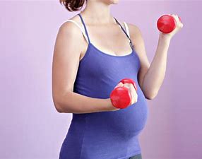 image of pregnant lady with dumbbells